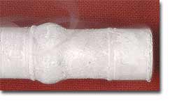 A cylinder bulges in the water ice portion, but is intact in the gas hydrate portion.